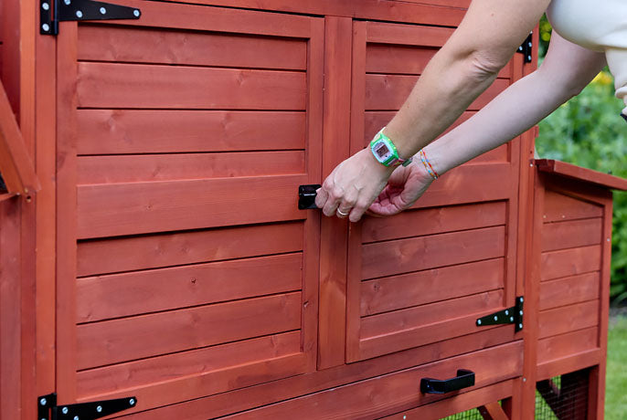 Secure predator-proof chicken coop doors with heavy-duty black bolt latch and rust-resistant hinges.