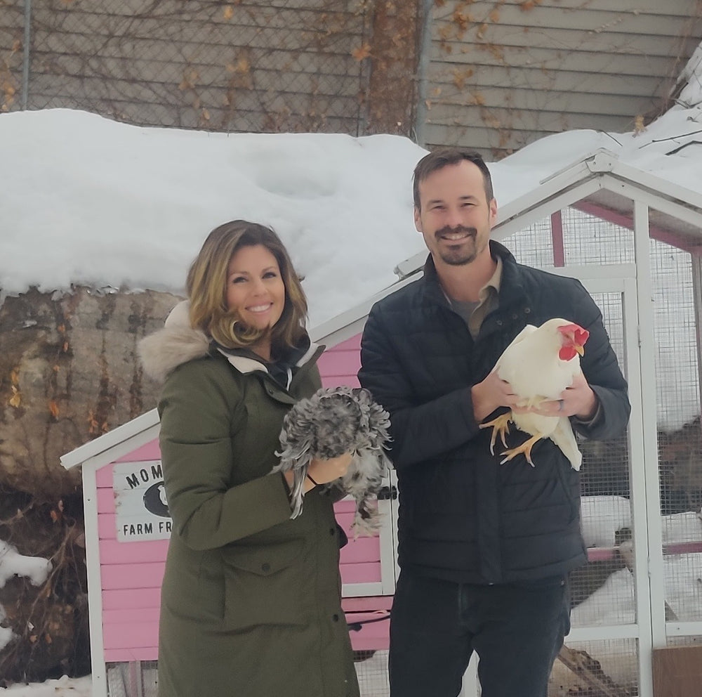 2 people Young Holding Two Chickens