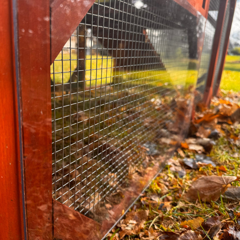 Clear plastic storm panels with hardware, designed to protect chicken coops in bad weather